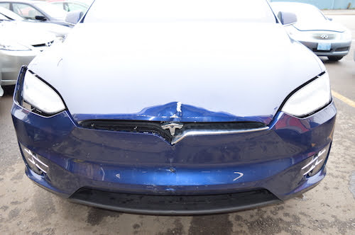 Tesla bumper before repair at an auto body shop in toronto 