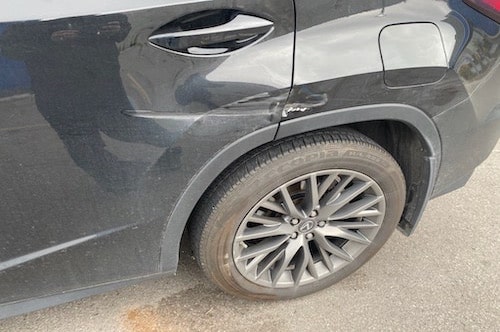 Lexus door and quarter panel damage before repair at an auto body shop in toronto
